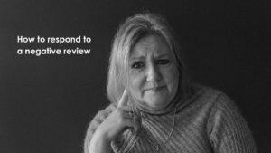 Black and white portrait of Mell Millgate, Starfish Marketing, looking thoughtful, with the text “How to respond to a negative review” beside her.